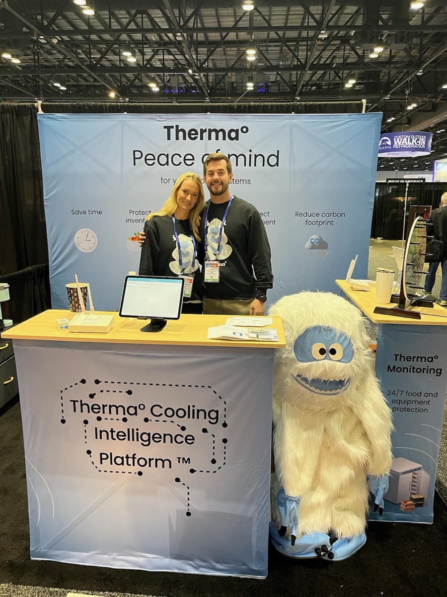 The Glacier Grid booth with a mascot at a trade show.