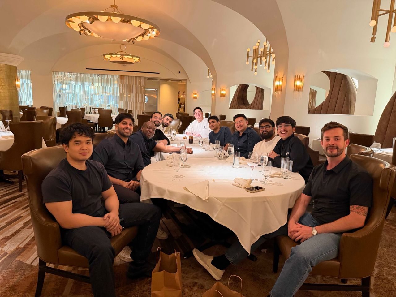 The Parameter AI team around a long table at a dinner.