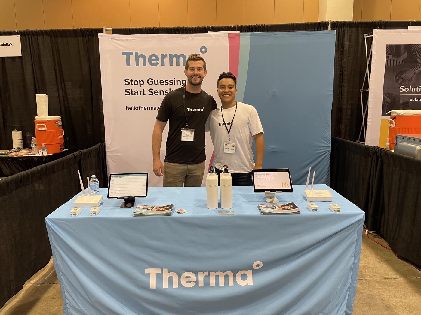 Tom Loebenstein with a Therma colleague behind the booth table.