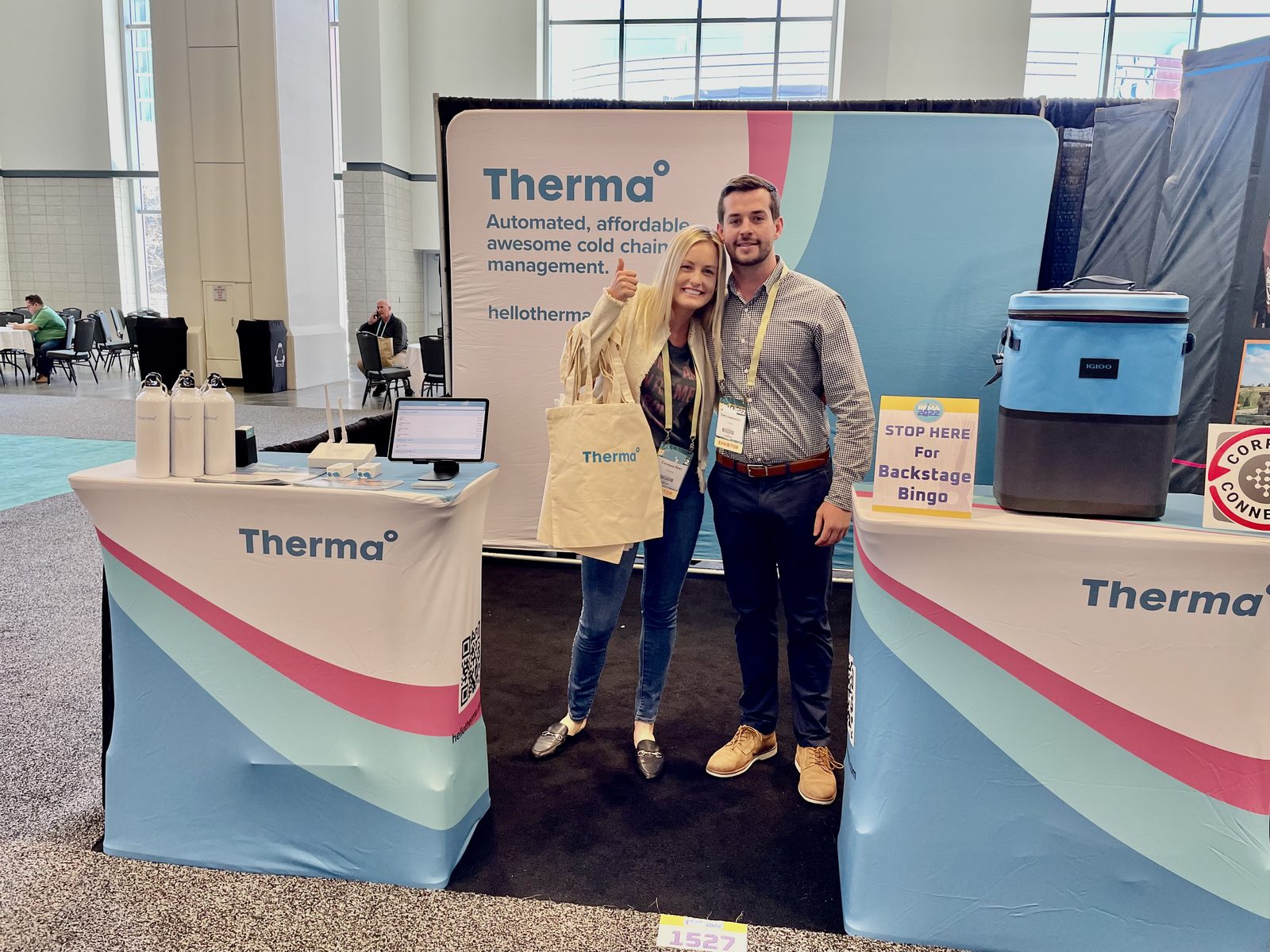 Tom Loebenstein and two colleagues at the Therma booth on a convention centre floor.