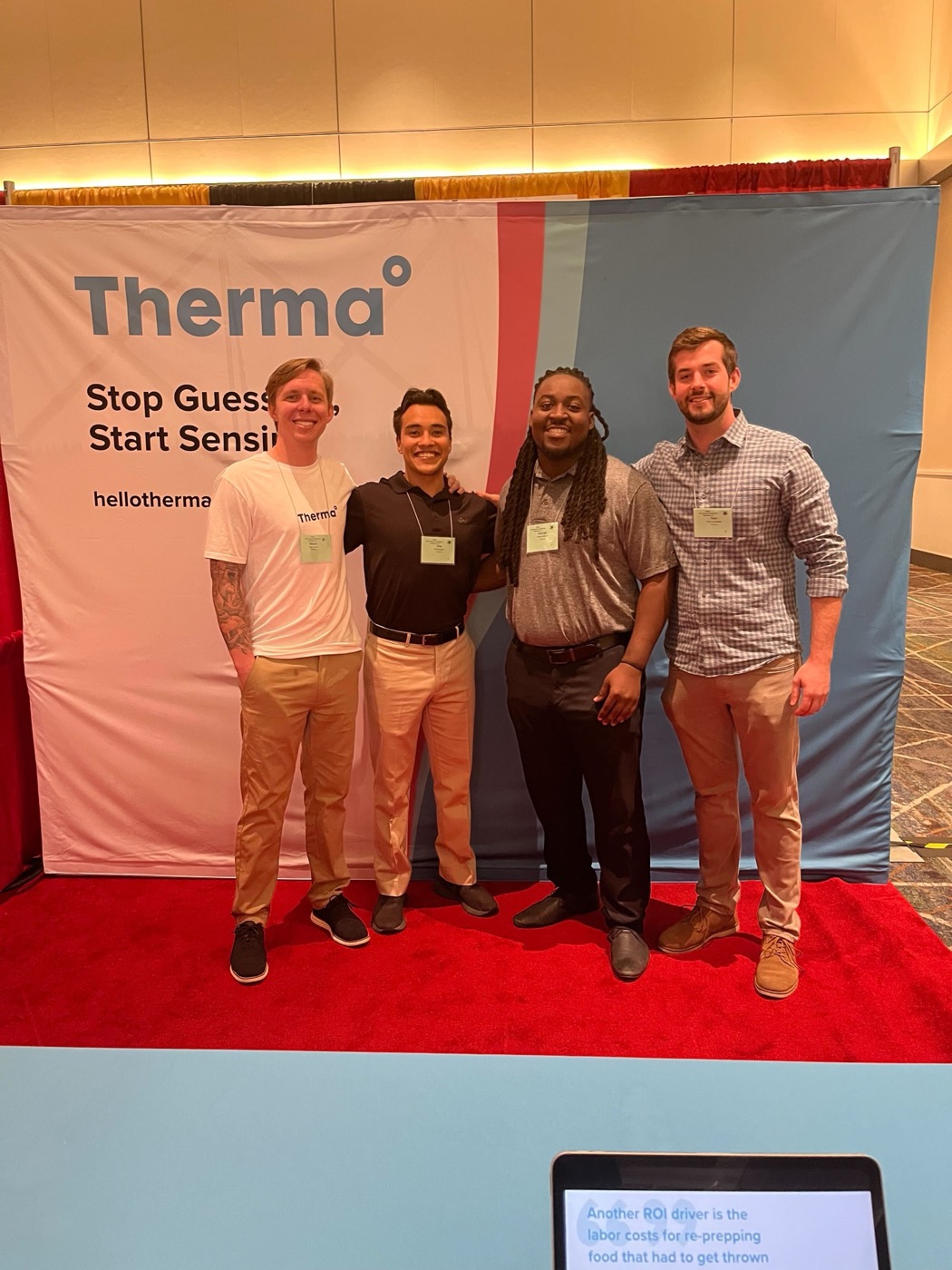 Tom Loebenstein with three Therma teammates in front of a Stop Guessing Start Sensing banner.